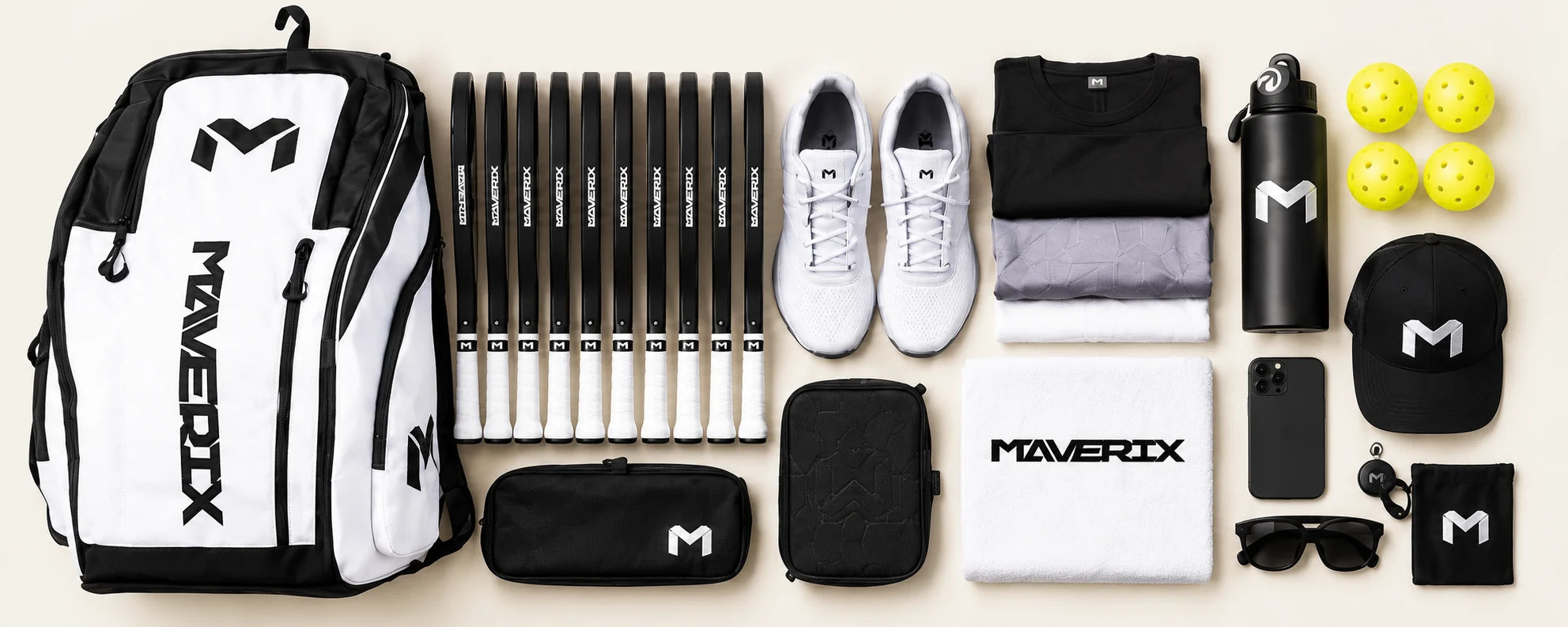 Titan Tour Pro with ten black-edge paddles, shoes, water, balls, clothes, towel and accessories laid out beside it.
